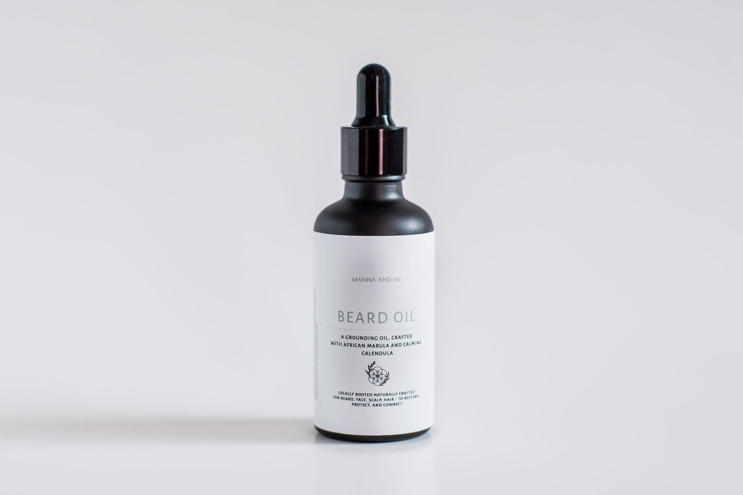 Manna and Me natural Beard Oil bottle with dropper, a soothing conditioning treatment crafted to prevent under-beard dryness and skin irritation.