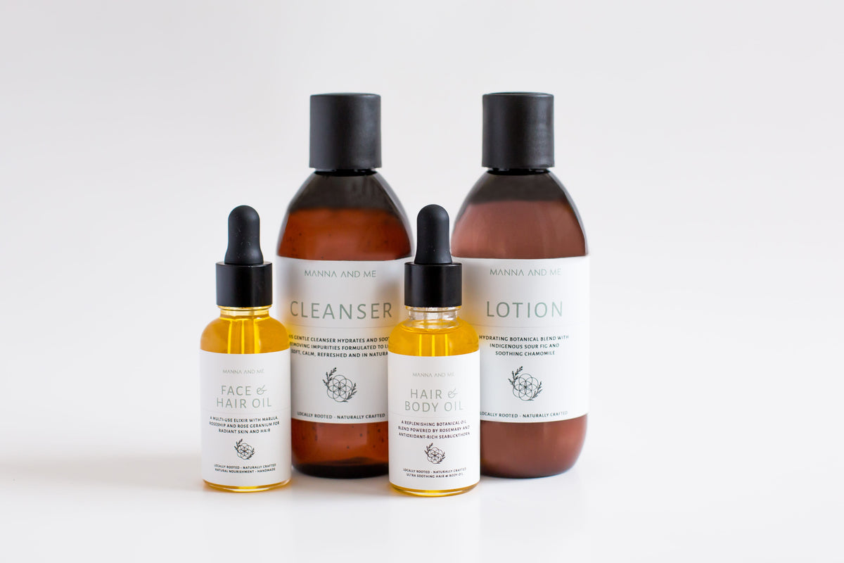 Manna and Me multi-use Hair and Body Oil glass bottle with natural botanical plant oils.